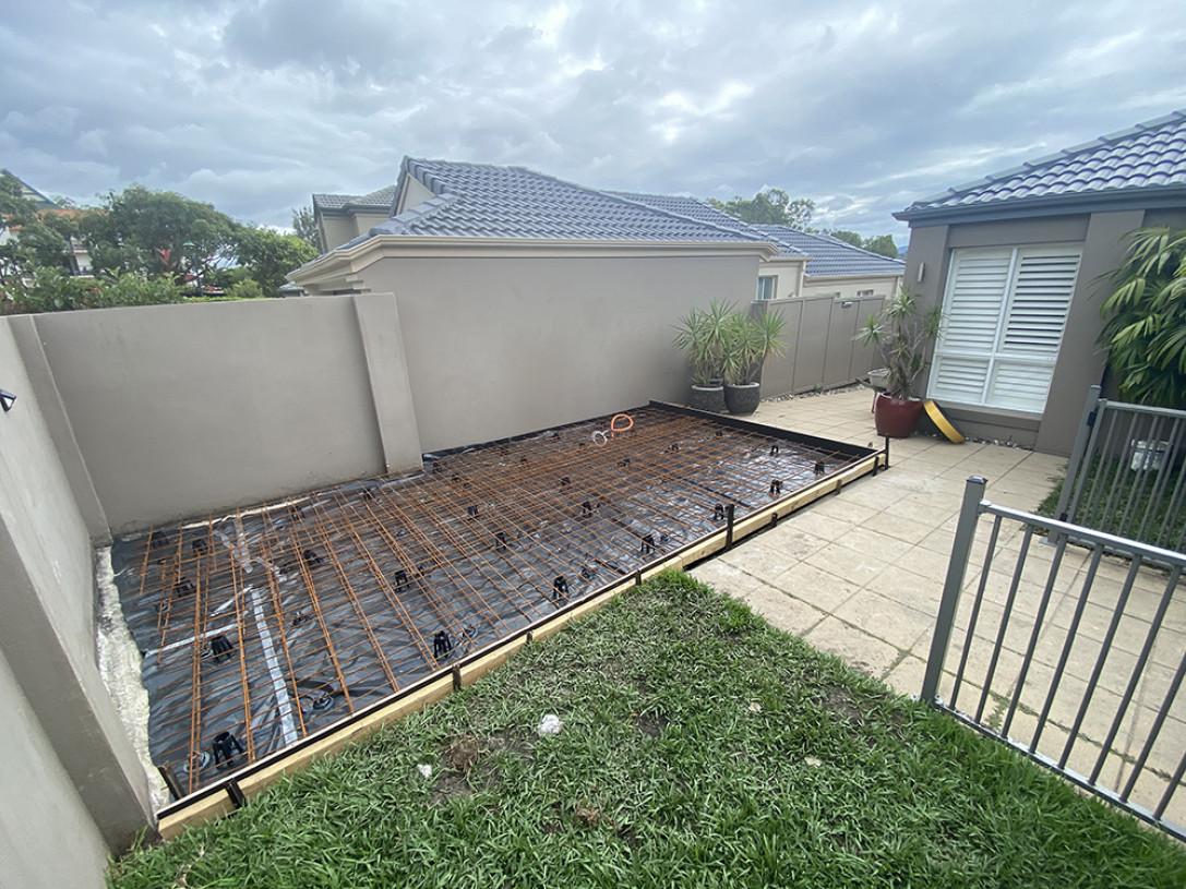 Digger preparing ground for concrete slab